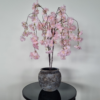Light pink artificial cherry blossom tree in a grey pot