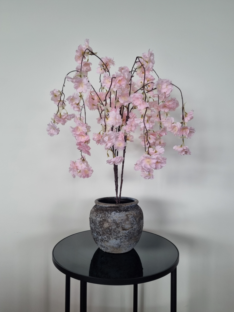 Light pink artificial cherry blossom tree in a grey pot