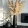 a tall vase with pampas