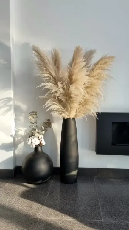 a tall vase with pampas